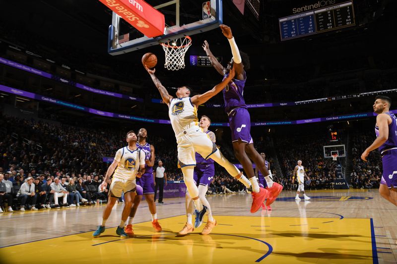 SAN FRANCISCO, CA - APRIL 14: Gui Santos #15 of the Golden State Warriors drives to the basket during the game against the Utah Jazz on April 14, 2024 at Chase Center in San Francisco, California. NOTE TO USER: User expressly acknowledges and agrees that, by downloading and or using this photograph, user is consenting to the terms and conditions of Getty Images License Agreement. Mandatory Copyright Notice: Copyright 2024 NBAE (Photo by Noah Graham/NBAE via Getty Images)