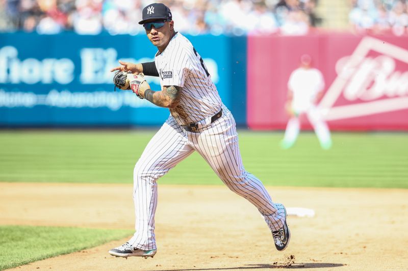 Aug 24, 2024; Bronx, New York, USA;  New York Yankees second base Gleyber Torres (25) is unable to make a throw to first base in the fifth inning against the Colorado Rockies at Yankee Stadium. Mandatory Credit: Wendell Cruz-USA TODAY Sports