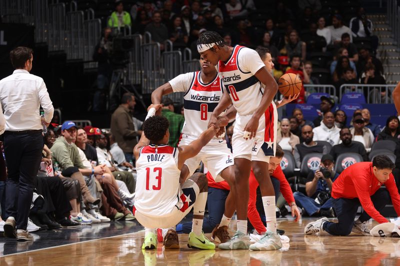 WASHINGTON, DC -? OCTOBER 30:  Jordan Poole #13 helped up by Carlton Carrington and Bilal Coulibaly #0 of the Washington Wizards during the game against the Atlanta Hawks during a regular season game on October 30, 2024 at Capital One Arena in Washington, DC. NOTE TO USER: User expressly acknowledges and agrees that, by downloading and or using this Photograph, user is consenting to the terms and conditions of the Getty Images License Agreement. Mandatory Copyright Notice: Copyright 2024 NBAE (Photo by Kenny Giarla/NBAE via Getty Images)