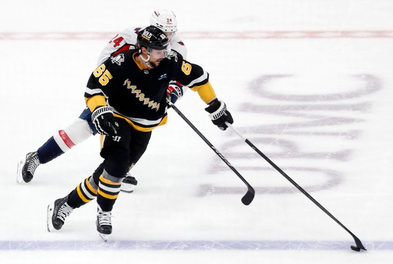 Mar 7, 2024; Pittsburgh, Pennsylvania, USA; Pittsburgh Penguins defenseman Erik Karlsson (65) moves the puck against Washington Capitals center Connor McMichael (24) at PPG Paints Arena. The Capitals shutout the Penguins 6-0. Mandatory Credit: Charles LeClaire-USA TODAY Sports