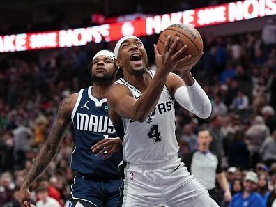 DALLAS, TX - DECEMBER 23: Devonte Graham #4 of the San Antonio Spurs drives to the basket during the game against the Dallas Mavericks on December 23, 2023 at the American Airlines Center in Dallas, Texas. NOTE TO USER: User expressly acknowledges and agrees that, by downloading and or using this photograph, User is consenting to the terms and conditions of the Getty Images License Agreement. Mandatory Copyright Notice: Copyright 2023 NBAE (Photo by Glenn James/NBAE via Getty Images)