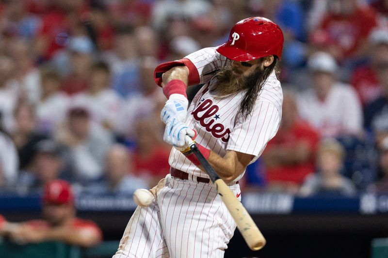 Aug 22, 2023; Philadelphia, Pennsylvania, USA; Philadelphia Phillies center fielder Brandon Marsh (16) hits a single during the ninth inning against the San Francisco Giants at Citizens Bank Park. Mandatory Credit: Bill Streicher-USA TODAY Sports