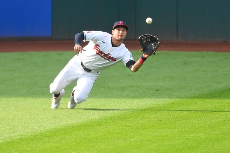 May 20, 2024; Cleveland, Ohio, USA; Cleveland Guardians center fielder Tyler Freeman (2) makes a catch in the first inning against the New York Mets at Progressive Field. Mandatory Credit: David Richard-USA TODAY Sports