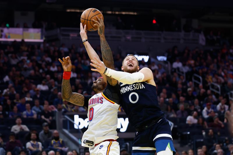 SAN FRANCISCO, CALIFORNIA - DECEMBER 08: Donte DiVincenzo #0 of the Minnesota Timberwolves and Gary Payton II #0 of the Golden State Warriors compete for the ball in the second quarter at Chase Center on December 08, 2024 in San Francisco, California. NOTE TO USER: User expressly acknowledges and agrees that, by downloading and or using this photograph, User is consenting to the terms and conditions of the Getty Images License Agreement. (Photo by Lachlan Cunningham/Getty Images)