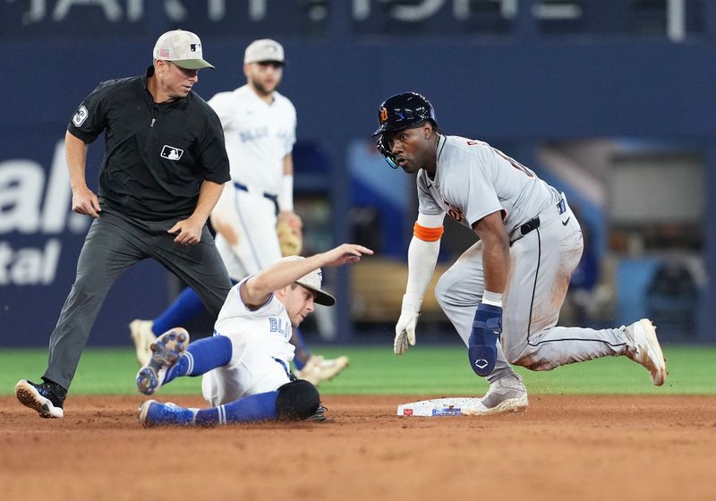 May 18, 2025; Toronto, Ontario, CAN; Detroit Tigers left fielder Akil Baddoo (60) steals second base ahead of the tag from Toronto Blue Jays second baseman Ernie Clement (22) during the eighth inning at Rogers Centre. Mandatory Credit: Nick Turchiaro-Imagn Images