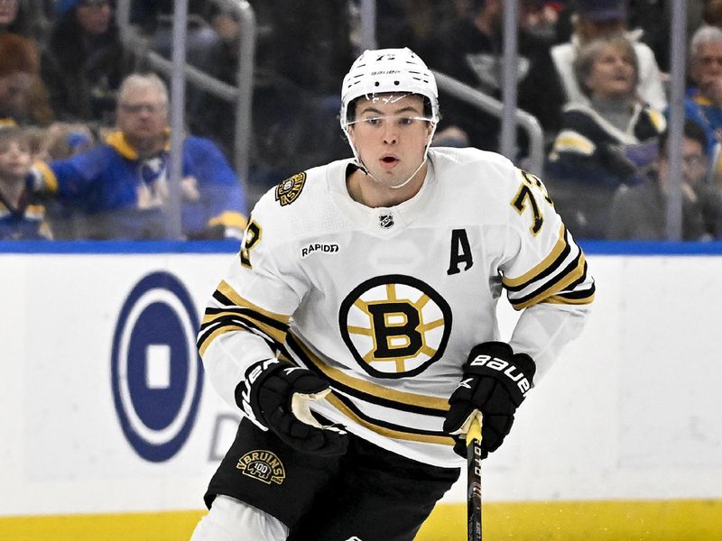 Jan 13, 2024; St. Louis, Missouri, USA;  Boston Bruins defenseman Charlie McAvoy (73) controls the puck against the St. Louis Blues during the third period at Enterprise Center. Mandatory Credit: Jeff Curry-USA TODAY Sports