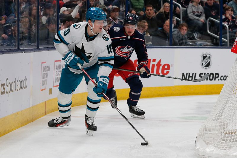 Mar 16, 2024; Columbus, Ohio, USA; San Jose Sharks center Klim Kostin (10) looks to pass as Columbus Blue Jackets center Alexander Texier (42) trails the play during the first period at Nationwide Arena. Mandatory Credit: Russell LaBounty-USA TODAY Sports