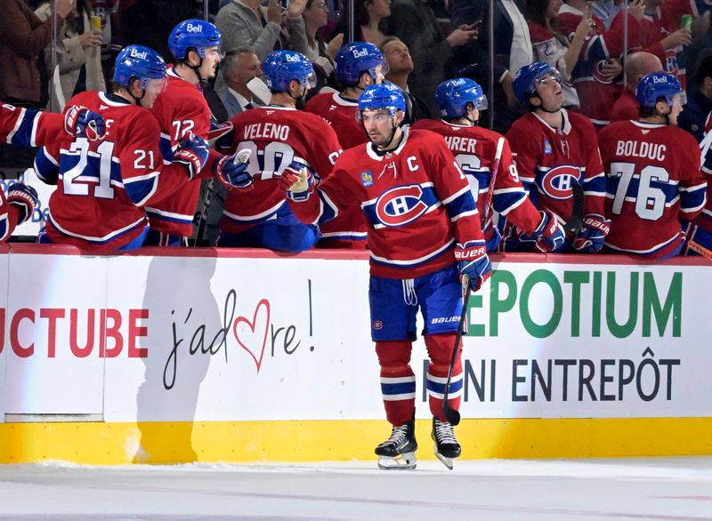 Sep 23, 2025; Montreal, Quebec, CAN; Montreal Canadiens forward Nick Suzuki (14) celebrates with teammates after scoring a goal against the Philadelphia Flyers during the second period at the Bell Centre. Mandatory Credit: Eric Bolte-Imagn Images