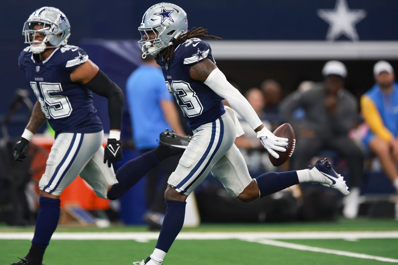 Dallas Cowboys safety Julius Wood (33) celebrates after intercepting a pass during the second half of a preseason NFL football game against the Los Angeles Chargers, Saturday, Aug. 24, 2024, in Arlington, Texas. (AP Photo/Gareth Patterson)