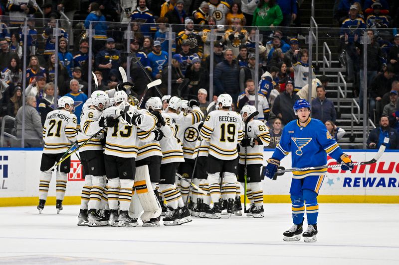 Jan 13, 2024; St. Louis, Missouri, USA;  Boston Bruins celebrate after defenseman Charlie McAvoy (73) scored the game winning goal in overtime against the St. Louis Blues at Enterprise Center. Mandatory Credit: Jeff Curry-USA TODAY Sports