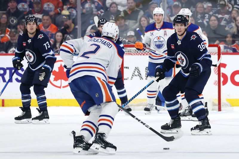 Apr 13, 2025; Winnipeg, Manitoba, CAN; Winnipeg Jets center Morgan Barron (36) defends Edmonton Oilers defenseman Evan Bouchard (2) in the second period at Canada Life Centre. Mandatory Credit: James Carey Lauder-Imagn Images