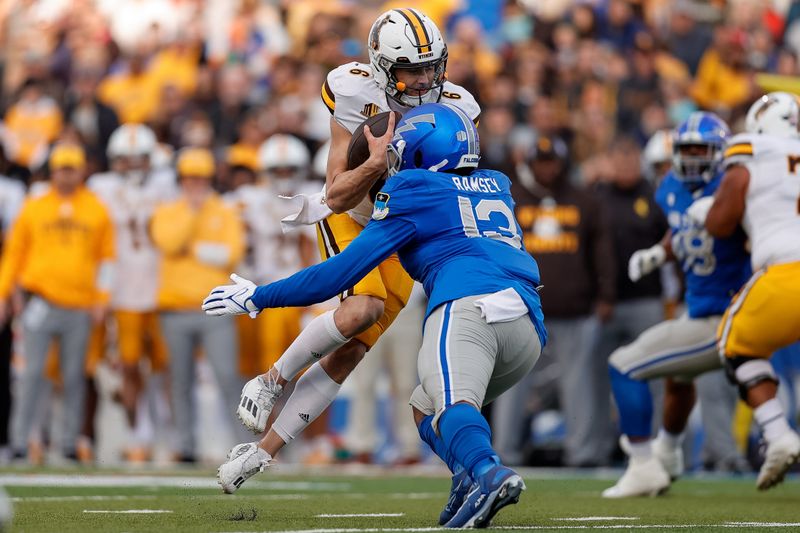 Oct 14, 2023; Colorado Springs, Colorado, USA; Wyoming Cowboys quarterback Andrew Peasley (6) is tackled by Air Force Falcons linebacker PJ Ramsey (13) in the first quarter at Falcon Stadium. Mandatory Credit: Isaiah J. Downing-USA TODAY Sports