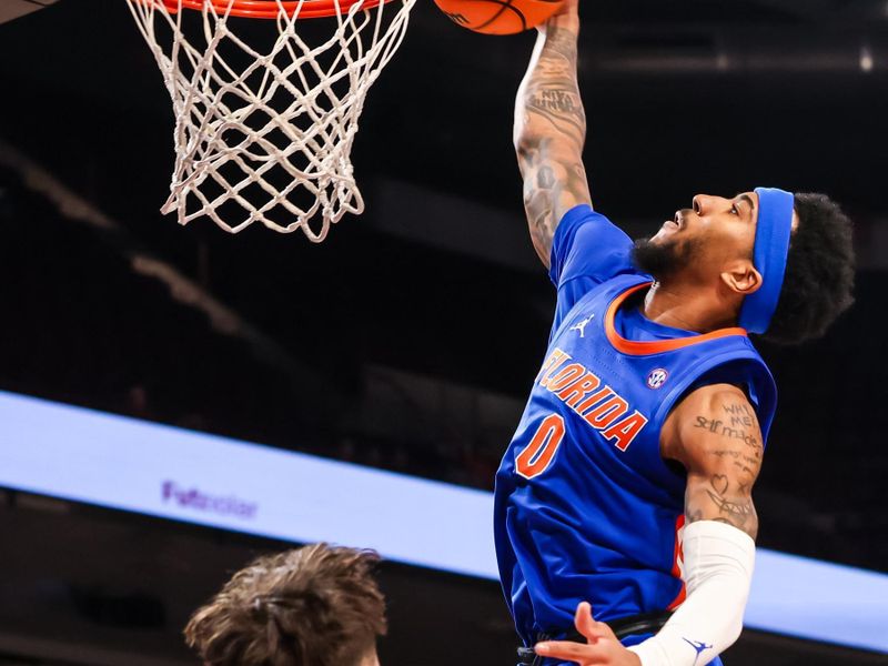 Jan 28, 2026; Columbia, South Carolina, USA; Florida Gators guard Boogie Fland (0) dunks over South Carolina Gamecocks guard Eli Ellis (15) in the second half at Colonial Life Arena. Mandatory Credit: Jeff Blake-Imagn Images