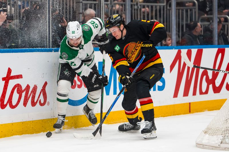 Mar 2, 2026; Vancouver, British Columbia, CAN; Vancouver Canucks defenseman Tom Willander (5) battles with Dallas Stars forward Mavrik Bourque (22) in the first period at Rogers Arena. Mandatory Credit: Bob Frid-Imagn Images