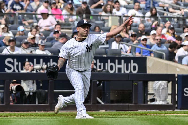 Apr 20, 2024; Bronx, New York, USA; New York Yankees pitcher Nestor Cortes (65) fields a bunt and throws to first base for an out during the fifth inning against the Tampa Bay Rays at Yankee Stadium. Mandatory Credit: John Jones-USA TODAY Sports