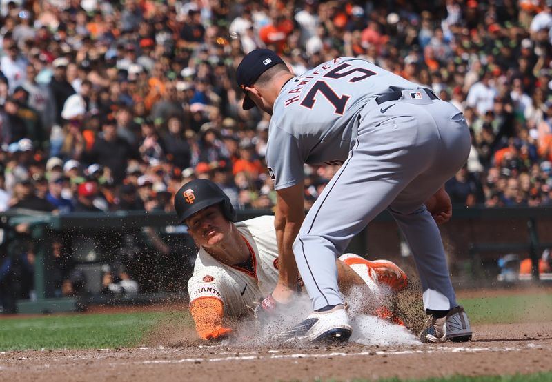 Aug 11, 2024; San Francisco, California, USA; Detroit Tigers relief pitcher Brenan Hanifee (75) tags out San Francisco Giants third baseman Matt Chapman (26) at home plate during the eighth inning at Oracle Park. Mandatory Credit: Kelley L Cox-USA TODAY Sports