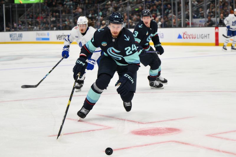 Jan 21, 2024; Seattle, Washington, USA; Seattle Kraken defenseman Jamie Oleksiak (24) chases the puck during the third period against the Toronto Maple Leafs at Climate Pledge Arena. Mandatory Credit: Steven Bisig-USA TODAY Sports