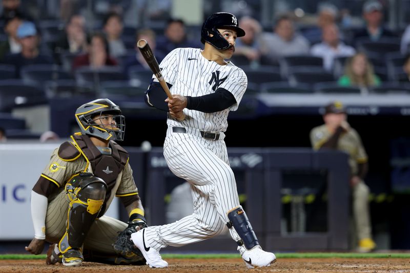 May 7, 2025; Bronx, New York, USA; New York Yankees pinch hitter Trent Grisham (12) follows through on a game tying two run home run against the San Diego Padres during the eighth inning at Yankee Stadium. Mandatory Credit: Brad Penner-Imagn Images
