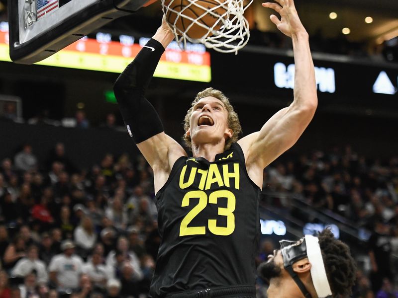 SALT LAKE CITY, UTAH - NOVEMBER 19: Lauri Markkanen #23 of the Utah Jazz dunks over Jordan Goodwin #0 of the Phoenix Suns during the first half of a game at Delta Center on November 19, 2023 in Salt Lake City, Utah. NOTE TO USER: User expressly acknowledges and agrees that, by downloading and or using this photograph, User is consenting to the terms and conditions of the Getty Images License Agreement. (Photo by Alex Goodlett/Getty Images)