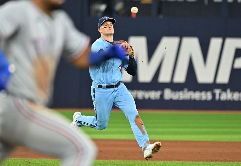 Sep 14, 2023; Toronto, Ontario, CAN;  Toronto Blue Jays third baseman Matt Chapman (26) throws out Texas Rangers left fielder Ezequiel Duran (20) in the fifth inning at Rogers Centre. Mandatory Credit: Dan Hamilton-USA TODAY Sports