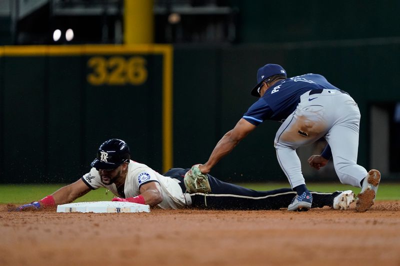 Jul 5, 2024; Arlington, Texas, USA; Texas Rangers outfielder Leody Taveras (3) is caught stealing second base as Tampa Bay Rays outfielder Richie Palacios (1) applies the tag during the third inning  at Globe Life Field. Mandatory Credit: Raymond Carlin III-USA TODAY Sports