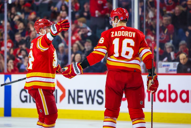 Apr 12, 2023; Calgary, Alberta, CAN; Calgary Flames defenseman Nikita Zadorov (16) celebrates his goal with defenseman MacKenzie Weegar (52) against the San Jose Sharks during the third period at Scotiabank Saddledome. Mandatory Credit: Sergei Belski-USA TODAY Sports