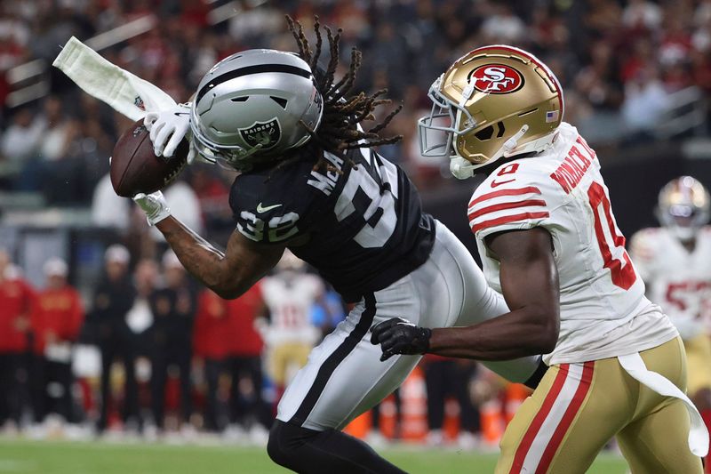 Las Vegas Raiders wide receiver Tyreik McAllister (32) makes a catch against San Francisco 49ers cornerback Samuel Womack III (0) before running it in for a touchdown during the second half of an NFL preseason football game, Friday, Aug. 23, 2024, in Las Vegas. (AP Photo/Ian Maule)