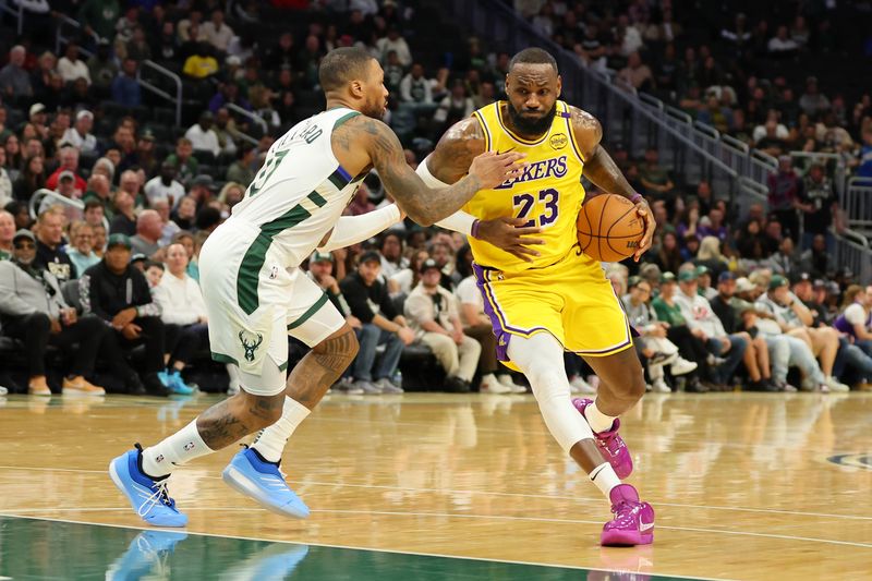 MILWAUKEE, WISCONSIN - OCTOBER 10: LeBron James #23 of the Los Angeles Lakers drives to the basket against Damian Lillard #0 of the Milwaukee Bucks during the first half of a preseason game at Fiserv Forum on October 10, 2024 in Milwaukee, Wisconsin.  NOTE TO USER: User expressly acknowledges and agrees that, by downloading and or using this photograph, User is consenting to the terms and conditions of the Getty Images License Agreement. (Photo by Stacy Revere/Getty Images)