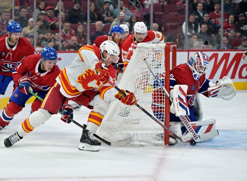 Nov 5, 2024; Montreal, Quebec, CAN; Montreal Canadiens goalie Sam Montembeault (35) stops Calgary Flames forward Blake Coleman (20) during the third period at the Bell Centre. Mandatory Credit: Eric Bolte-Imagn Images