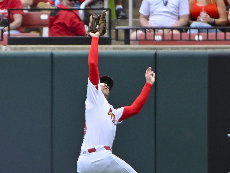 May 5, 2024; St. Louis, Missouri, USA;  St. Louis Cardinals center fielder Dylan Carlson (3) leaps and catches a line drive against the Chicago White Sox during the sixth inning at Busch Stadium. Mandatory Credit: Jeff Curry-USA TODAY Sports