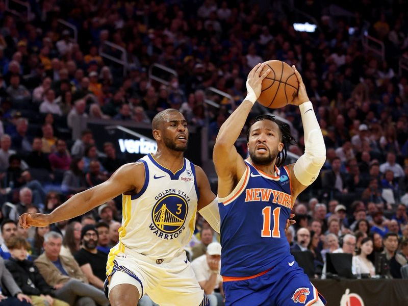 SAN FRANCISCO, CALIFORNIA - MARCH 18: Jalen Brunson #11 of the New York Knicks is guarded by Chris Paul #3 of the Golden State Warriors in the first half at Chase Center on March 18, 2024 in San Francisco, California. NOTE TO USER: User expressly acknowledges and agrees that, by downloading and or using this photograph, User is consenting to the terms and conditions of the Getty Images License Agreement.  (Photo by Ezra Shaw/Getty Images)