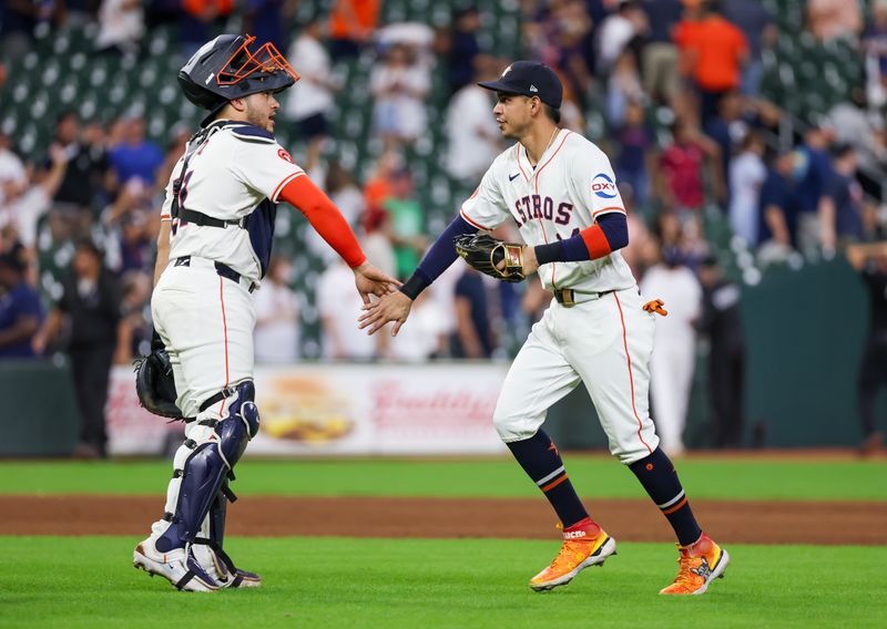 Aug 29, 2024; Houston, Texas, USA;  Houston Astros catcher Yainer Diaz (21) and left fielder Mauricio Dubon (14) celebrate the win after defeating the Kansas City Royals at Minute Maid Park. Mandatory Credit: Thomas Shea-USA TODAY Sports