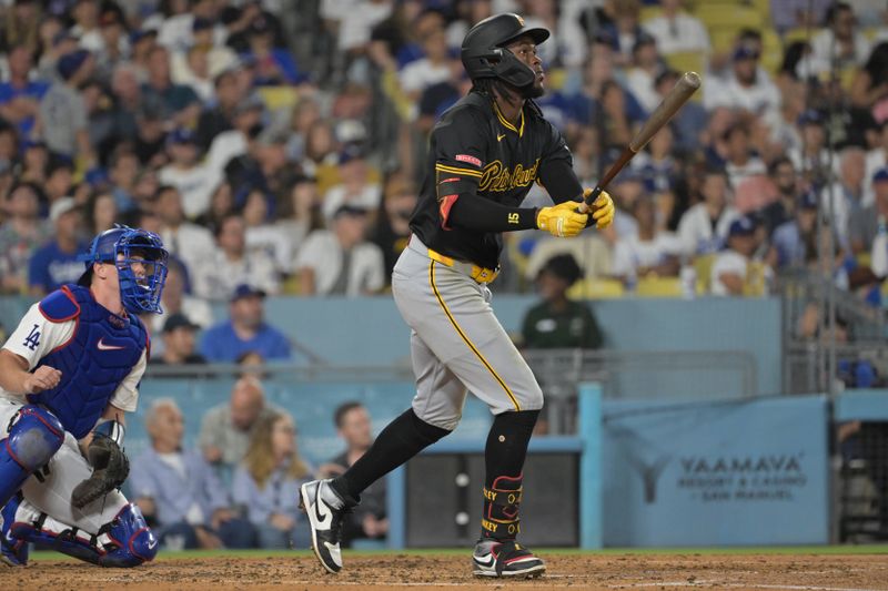 Aug 9, 2024; Los Angeles, California, USA; Pittsburgh Pirates shortstop Oneil Cruz (15) hits a solo home run in the fourth inning against the Los Angeles Dodgers at Dodger Stadium. Mandatory Credit: Jayne Kamin-Oncea-USA TODAY Sports