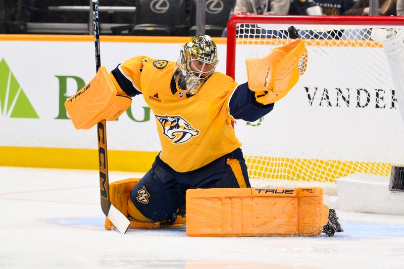 Jan 8, 2026; Nashville, Tennessee, USA; Nashville Predators goaltender Juuse Saros (74) has the puck go off of his glove against the New York Islanders during the second period at Bridgestone Arena. Mandatory Credit: Steve Roberts-Imagn Images