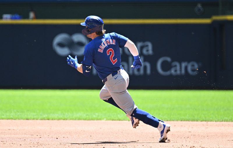 May 30, 2024; Milwaukee, Wisconsin, USA; Chicago Cubs second base Nico Hoerner (2) rounds first base for a double against the Milwaukee Brewers in the second inning  at American Family Field. Mandatory Credit: Michael McLoone-USA TODAY Sports