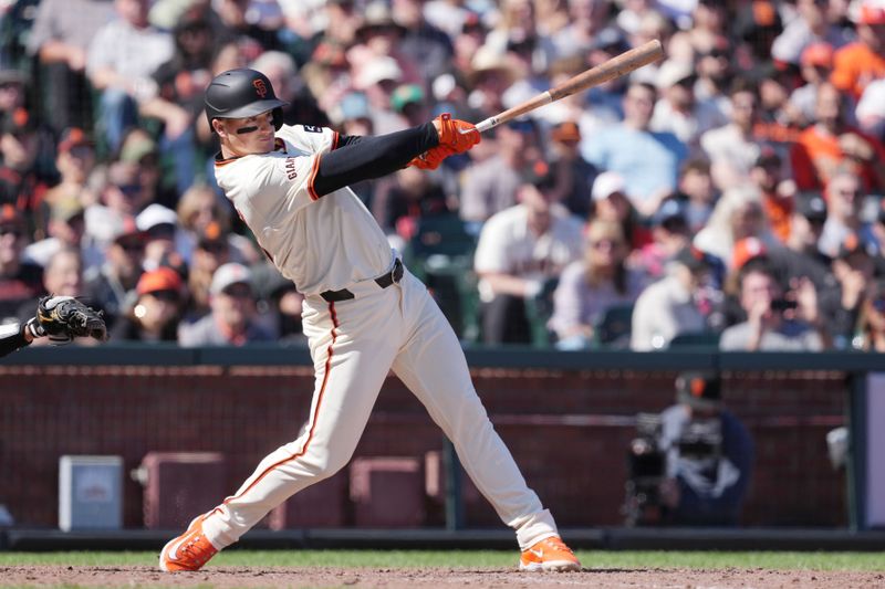 Apr 7, 2024; San Francisco, California, USA; San Francisco Giants third baseman Matt Chapman (26) hits an RBI single against the San Diego Padres during the eighth inning at Oracle Park. Mandatory Credit: Darren Yamashita-USA TODAY Sports