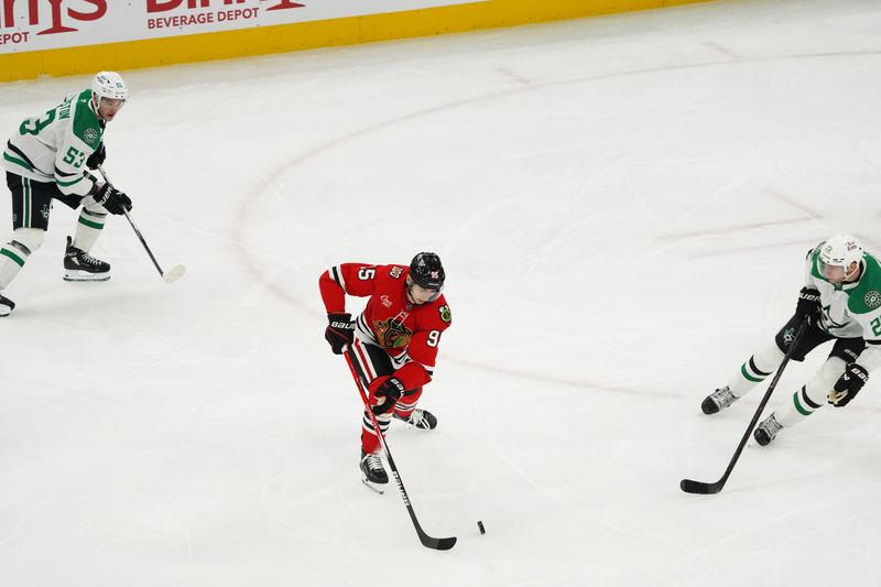 Jan 1, 2026; Chicago, Illinois, USA; Dallas Stars defenseman Esa Lindell (23) defends Chicago Blackhawks right wing Ilya Mikheyev (95) during the second period at United Center. Mandatory Credit: David Banks-Imagn Images