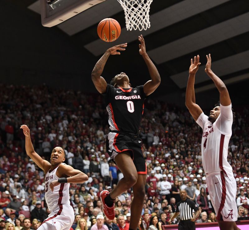 Feb 18, 2023; Tuscaloosa, Alabama, USA; Alabama guard Nimari Burnett (25) and Alabama forward Noah Gurley (4) defend as Georgia guard Terry Roberts (0) attempts a layup at Coleman Coliseum. Mandatory Credit: Gary Cosby Jr.-USA TODAY Sports