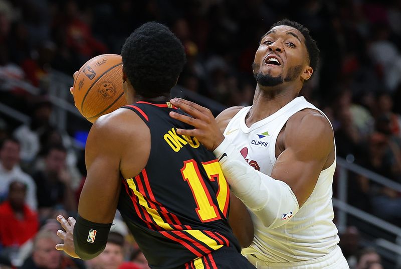 ATLANTA, GEORGIA - NOVEMBER 29:  Donovan Mitchell #45 of the Cleveland Cavaliers drives against Onyeka Okongwu #17 of the Atlanta Hawks during the third quarter of the Emirates NBA Cup game at State Farm Arena on November 29, 2024 in Atlanta, Georgia.  NOTE TO USER: User expressly acknowledges and agrees that, by downloading and/or using this photograph, user is consenting to the terms and conditions of the Getty Images License Agreement.  (Photo by Kevin C. Cox/Getty Images)