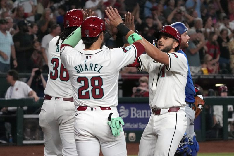 Sep 11, 2024; Phoenix, Arizona, USA; Arizona Diamondbacks catcher Adrian Del Castillo (25) celebrates with Josh Bell (36) and Eugenio Suárez (28) after hitting a three-run home run against the Texas Rangers in the fifth inning at Chase Field. Mandatory Credit: Rick Scuteri-Imagn Images