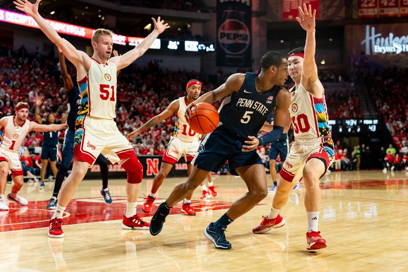 Feb 17, 2024; Lincoln, Nebraska, USA; Penn State Nittany Lions guard Jameel Brown (5) looks to pass against Nebraska Cornhuskers guard Keisei Tominaga (30), guard Jamarques Lawrence (10) and forward Rienk Mast (51) during the second half at Pinnacle Bank Arena. Mandatory Credit: Dylan Widger-USA TODAY Sports