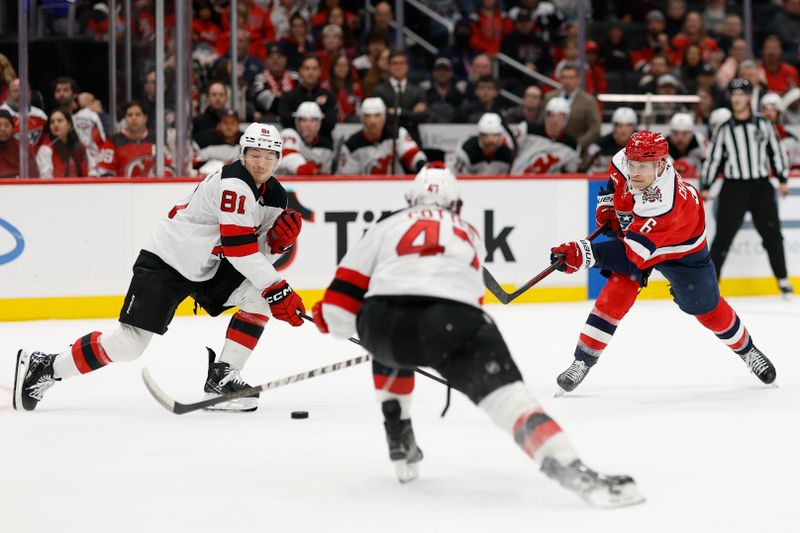 Nov 15, 2025; Washington, District of Columbia, USA; Washington Capitals defenseman Jakob Chychrun (6) shoots the puck as New Jersey Devils right wing Arseny Gritsyuk (81) and Devils left wing Paul Cotter (47) defend during the third period at Capital One Arena. Mandatory Credit: Geoff Burke-Imagn Images