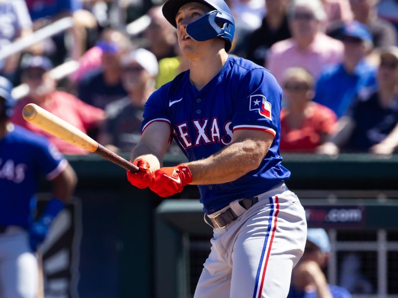 Mar 20, 2024; Goodyear, Arizona, USA; Texas Rangers outfielder Wyatt Langford hits a home run against the Cincinnati Reds during a spring training baseball game at Goodyear Ballpark. Mandatory Credit: Mark J. Rebilas-USA TODAY Sports
