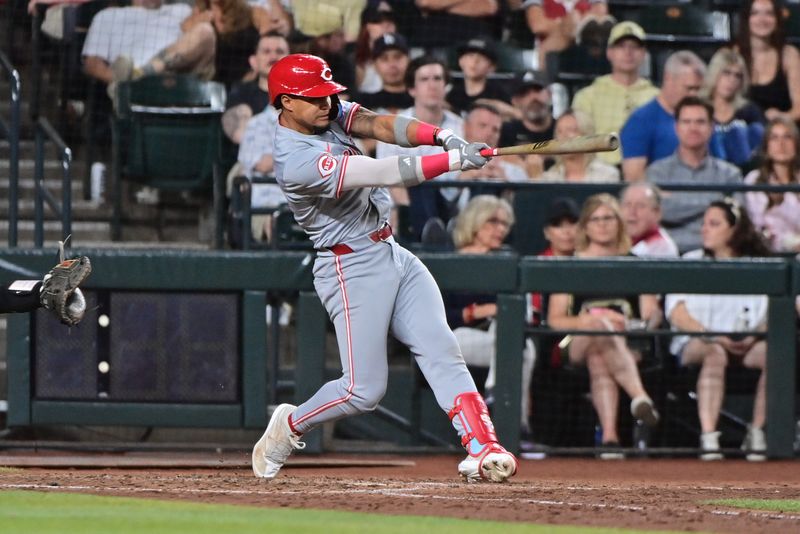 May 14, 2024; Phoenix, Arizona, USA; Cincinnati Reds second baseman Santiago Espinal (4) hits a RBI single in the sixth inning against the Arizona Diamondbacks at Chase Field. Mandatory Credit: Matt Kartozian-USA TODAY Sports