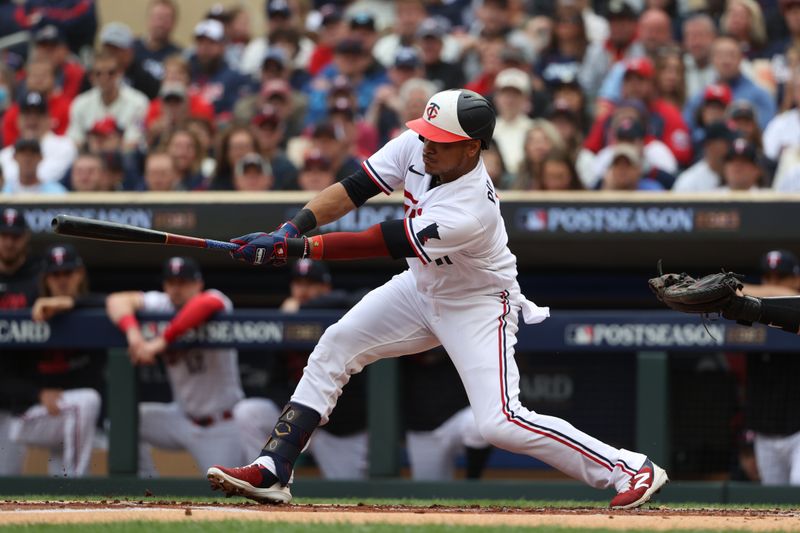 Oct 4, 2023; Minneapolis, Minnesota, USA; Minnesota Twins second baseman Jorge Polanco (11) hits a single a single in the in the first inning against the Toronto Blue Jays  during game two of the Wildcard series for the 2023 MLB playoffs at Target Field. Mandatory Credit: Jesse Johnson-USA TODAY Sports