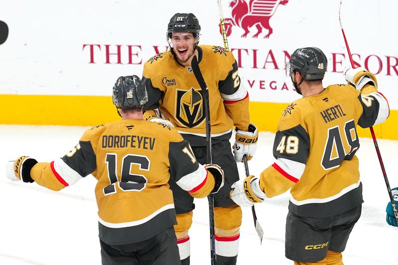 Oct 26, 2024; Las Vegas, Nevada, USA; Vegas Golden Knights center Brett Howden (21) celebrates with Vegas Golden Knights left wing Pavel Dorofeyev (16) and Vegas Golden Knights center Tomas Hertl (48) after scoring a goal against the San Jose Sharks during the third period at T-Mobile Arena. Mandatory Credit: Stephen R. Sylvanie-Imagn Images