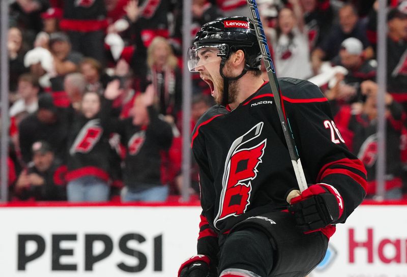 May 12, 2025; Raleigh, North Carolina, USA; Carolina Hurricanes defenseman Sean Walker (26) scores a goal against the Washington Capitals during the third period in game four of the second round of the 2025 Stanley Cup Playoffs at Lenovo Center. Mandatory Credit: James Guillory-Imagn Images