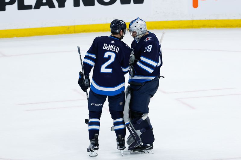 Apr 18, 2024; Winnipeg, Manitoba, CAN;  Winnipeg Jets goalie Laurent Boissoit (39) is congratulated defenseman Dylan DeMelo (2) on his win against the Vancouver Canucks at the end of the third period at Canada Life Centre. Mandatory Credit: Terrence Lee-USA TODAY Sports