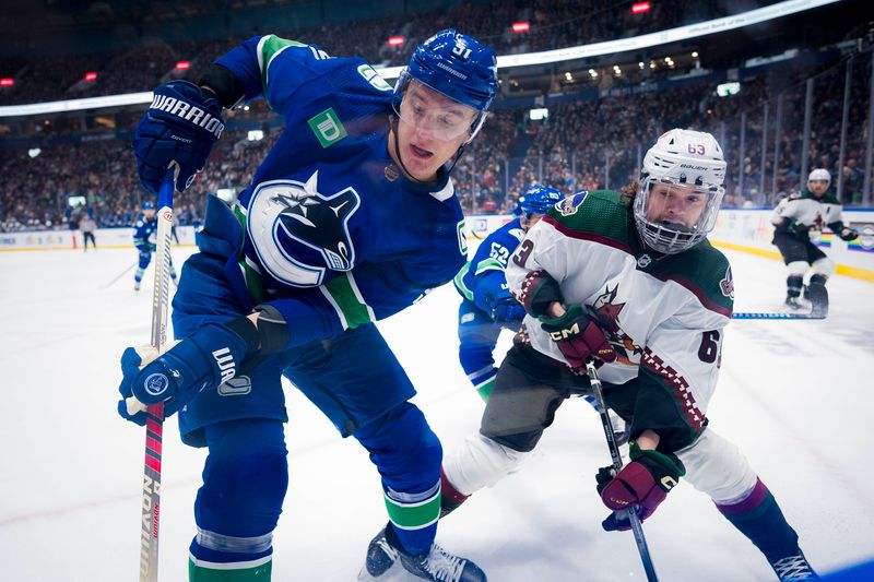 sJan 18, 2024; Vancouver, British Columbia, CAN; Arizona Coyotes forward Matias Maccelli (63) battles with Vancouver Canucks defenseman Nikita Zadorov (91) in the first period at Rogers Arena. Mandatory Credit: Bob Frid-USA TODAY Sports