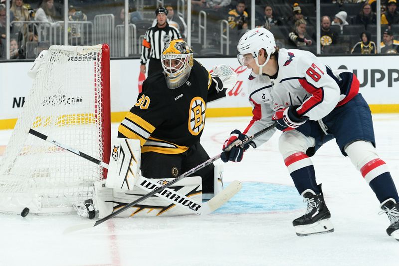 Sep 21, 2025; Boston, Massachusetts, USA;  Washington Capitals forward Bogdan Trineyev (87) loses control of the puck in front of Boston Bruins goaltender Michael DiPietro (80) during the second period at TD Garden. Mandatory Credit: Bob DeChiara-Imagn Images